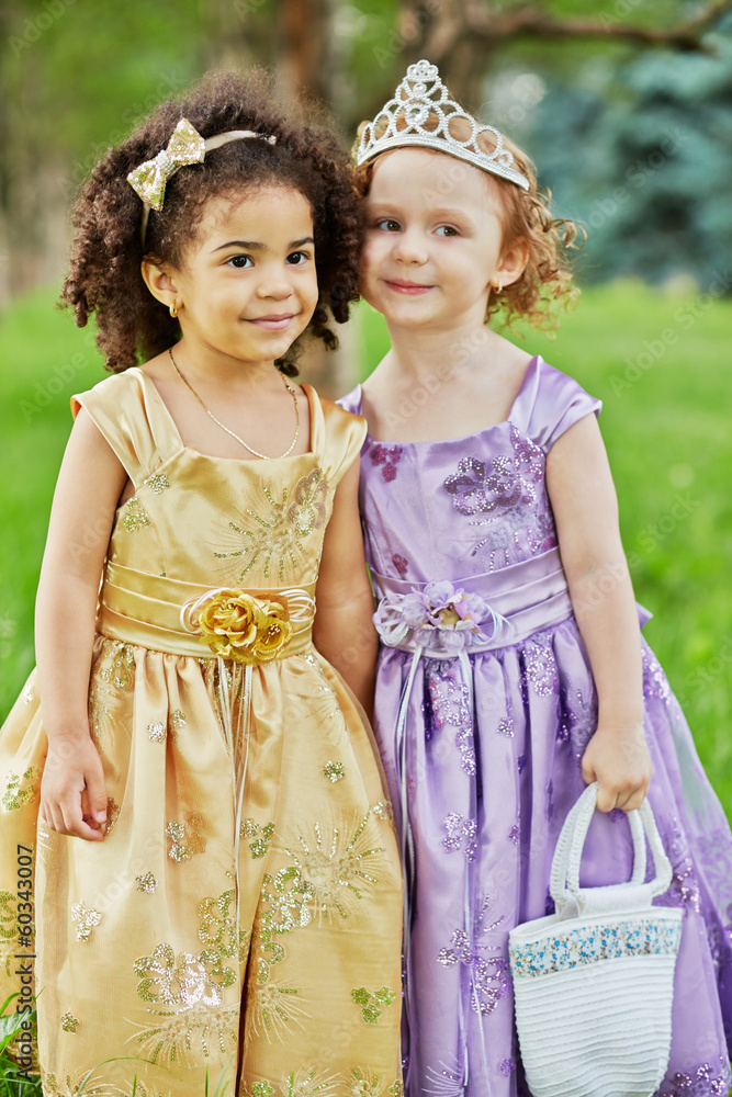 Two little girls in beautiful gowns stand together Stock Photo | Adobe ...