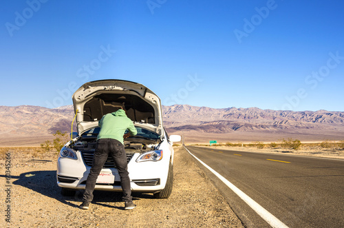 Broken down car in the middle of the desert
