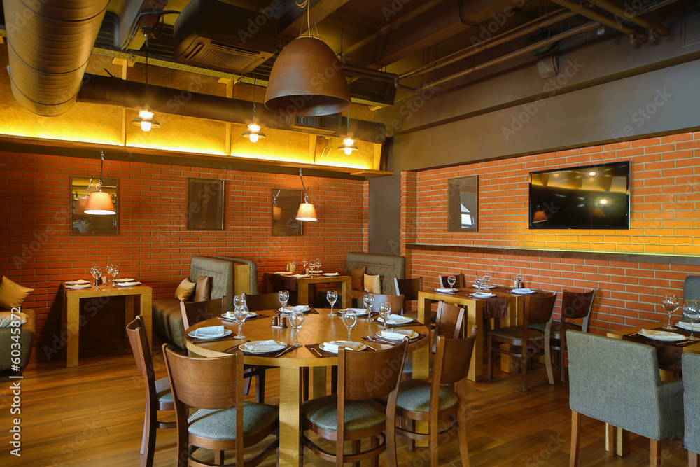 Restaurant hall with wooden round table in the center Restaurant hall with wooden round table in the center