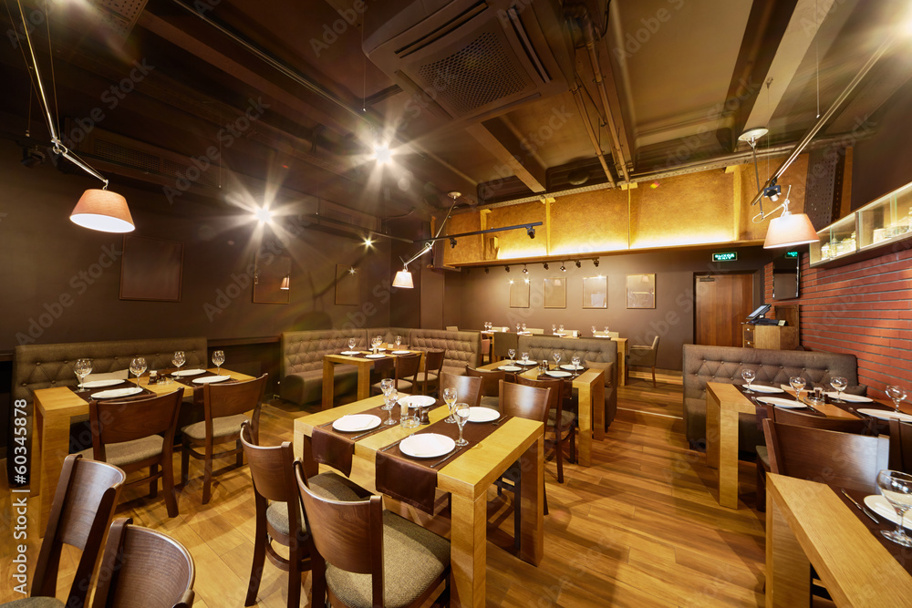 Interior of room in restaurant with wooden furniture