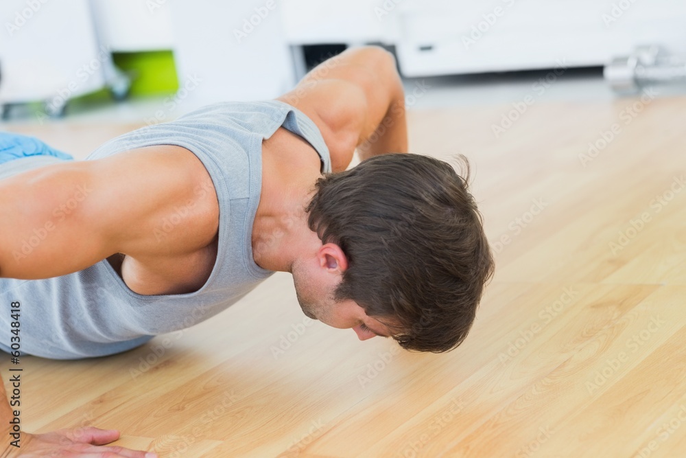 Determined man doing push ups in gym Determined man doing push ups in gym