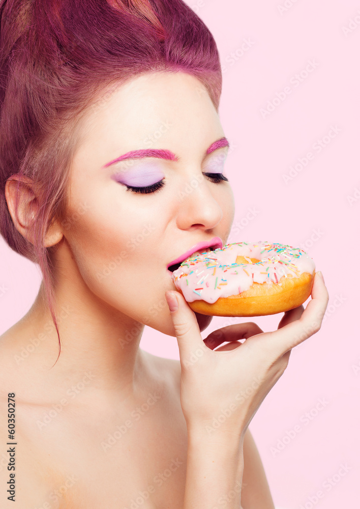 girl eating a donut with icing