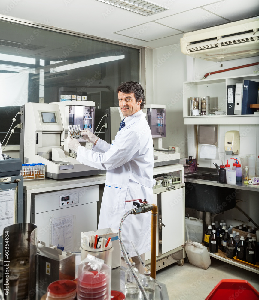 Scientist Analyzing Urine Samples In Laboratory Scientist Analyzing Urine Samples In Laboratory