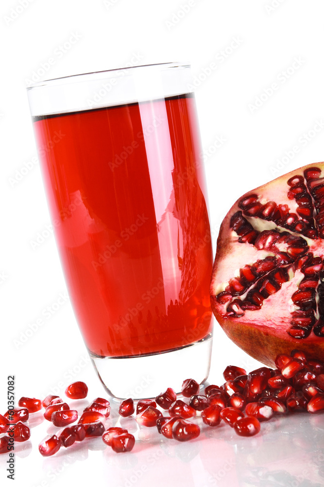 Isolated pomegranate juice in a glass and ripe pomegranate. Isolated pomegranate juice in a glass and ripe pomegranate.