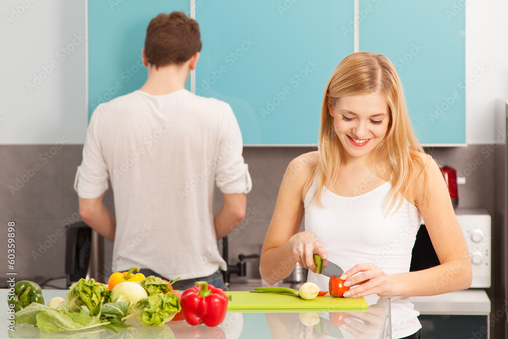 Young beautiful couple cooking at home Young beautiful couple cooking at home