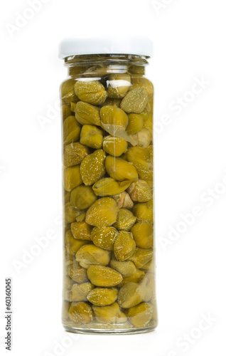 capers in a glass jar isolated on white