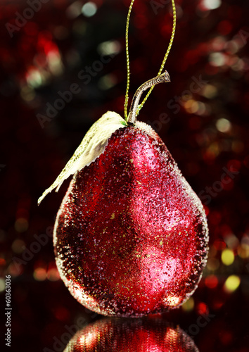 Christmas decoration, red pear on a bright tinsel