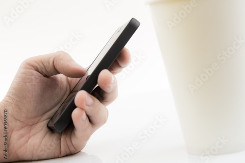 Businessman Using Cell Phone with coffee cup