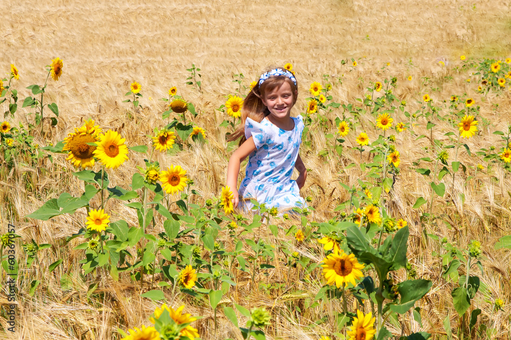 Fototapeta premium happy small girl running in a field