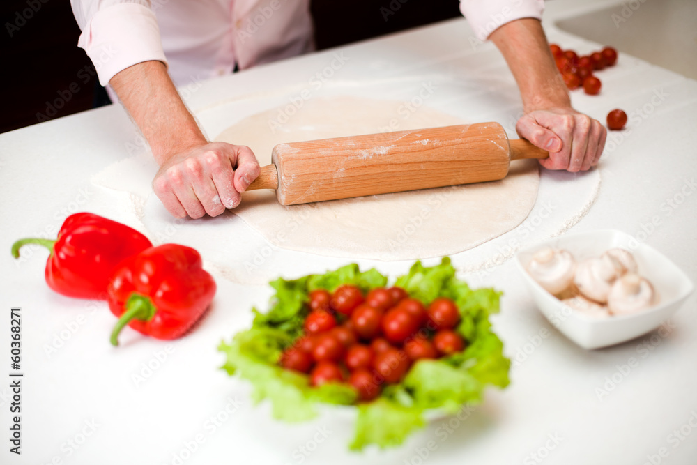 Preparing a dough for italian pizza close up