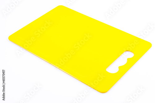Yellow plastic cutting board on isolated white background