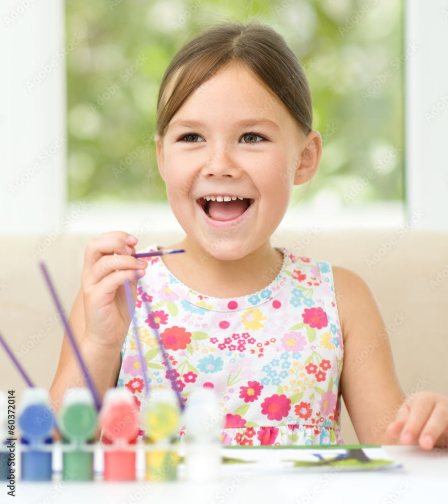 Little girl is painting with gouache Little girl is painting with gouache