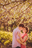 Portrait of young couple in flowering park