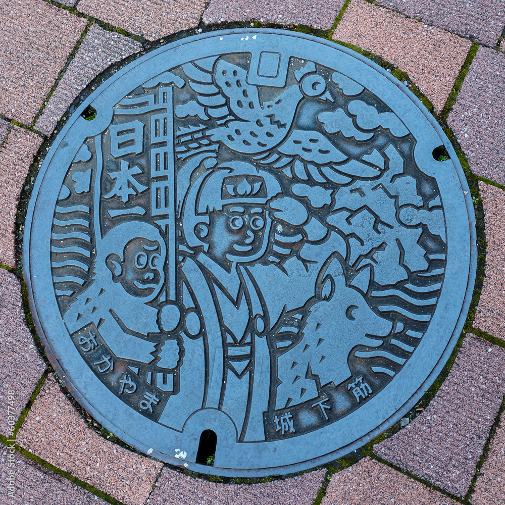 Naklejka premium Momotaro character on a Manhole