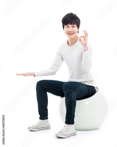 Asian man present something
