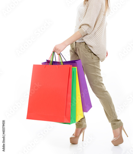 shopping girl, young woman on high heels with colored shopping b