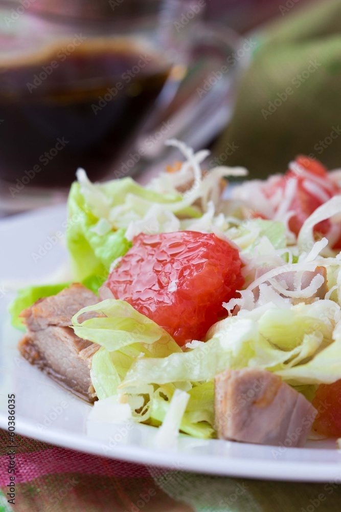 Delicious fresh salad with grapefruit, chicken, lettuce, cheese