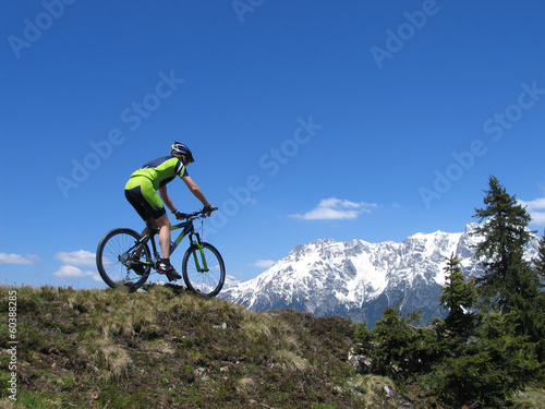 Mountain biker riding through European Alps
