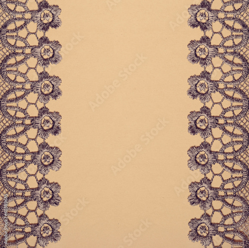 Gray lace on beige paper