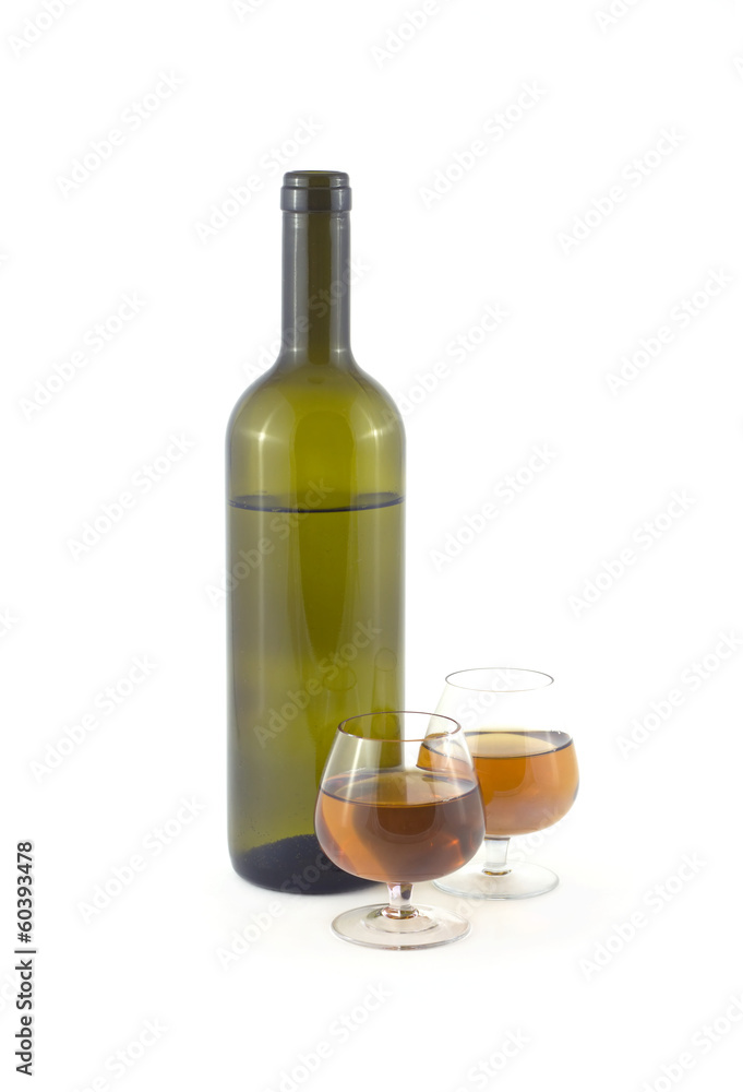 Two glasses with sweet dessert wine and bottle isolated close up Two glasses with sweet dessert wine and bottle isolated close up