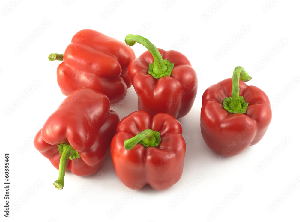 Five whole red ripe bell peppers isolated close up Five whole red ripe bell peppers isolated close up