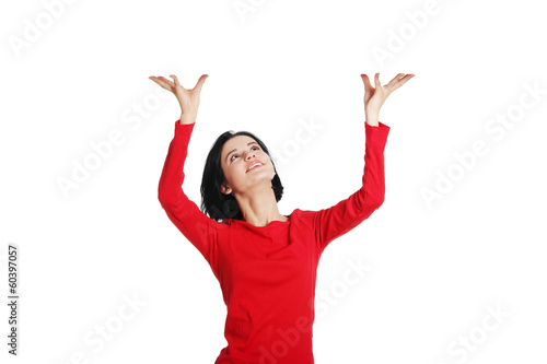 Woman is holding something abstract above her head.