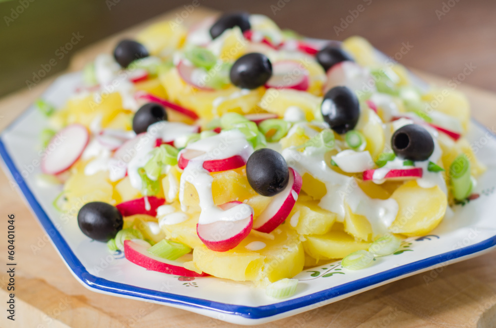 Potato and yogurt salad with black olives and radish