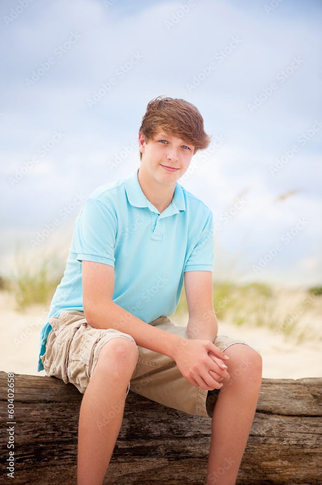 teen boy smiling on the beach