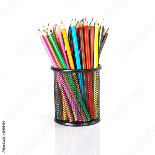 Colorful pencils in a black basket over a white background