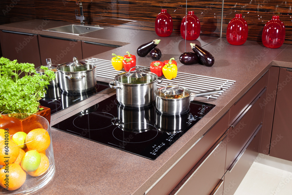 Modern kitchen with glass induction hob. Modern kitchen with glass induction hob.