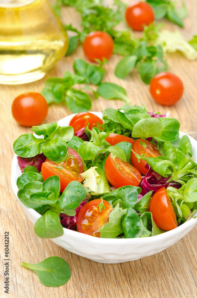 bowl of fresh salad and cherry tomatoes in white bowl, vertical bowl of fresh salad and cherry tomatoes in white bowl, vertical