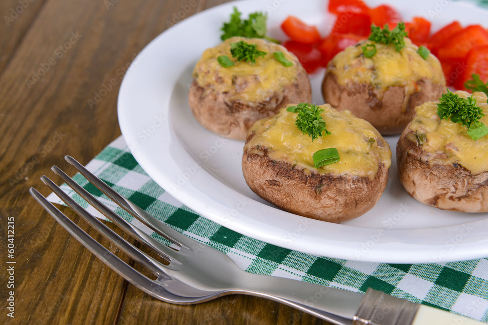 Stuffed mushrooms on plate on table close-up Stuffed mushrooms on plate on table close-up