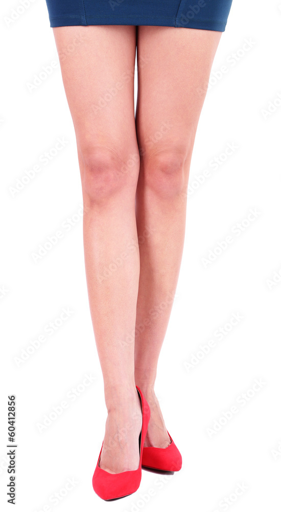 Beautiful female legs in red shoes isolated on white Beautiful female legs in red shoes isolated on white
