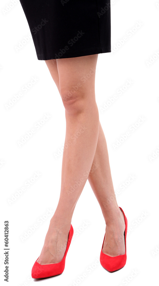 Beautiful female legs in red shoes isolated on white Beautiful female legs in red shoes isolated on white