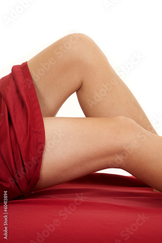 Woman legs red sheet knees