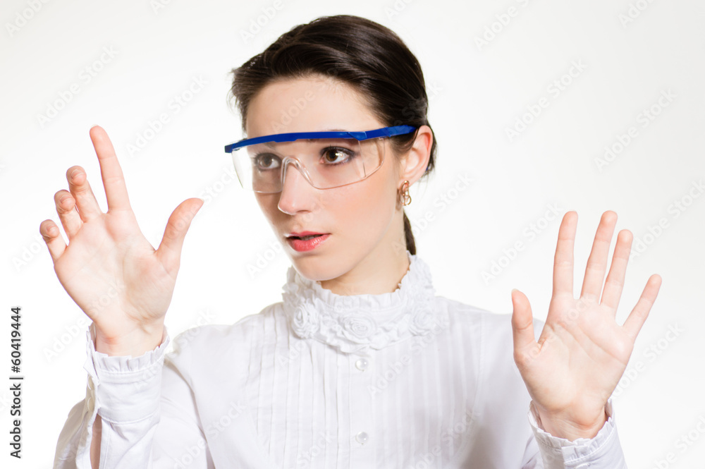 Young woman in eye shields working on virtual touch screen Young woman in eye shields working on virtual touch screen