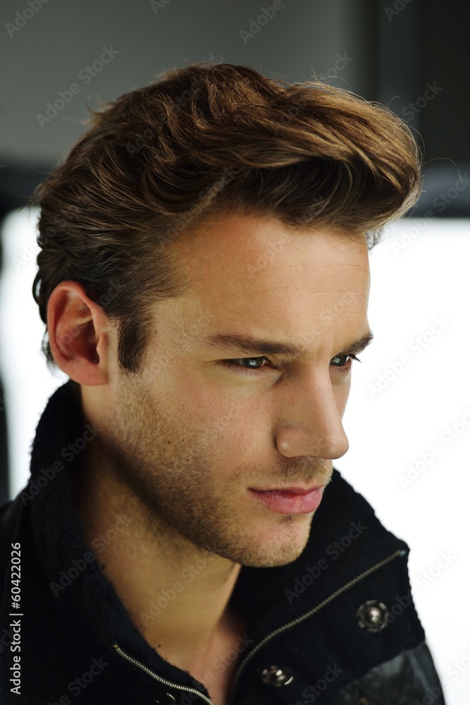 Naklejka premium Young man studio shoot posing closeup