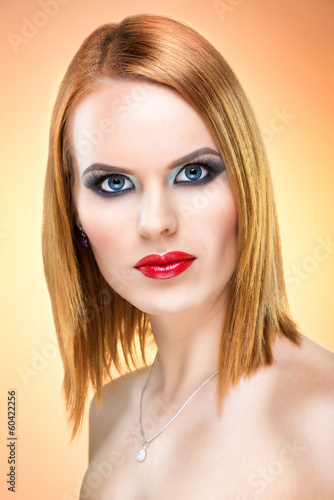Beautiful blue-eyed woman with extreme makeup