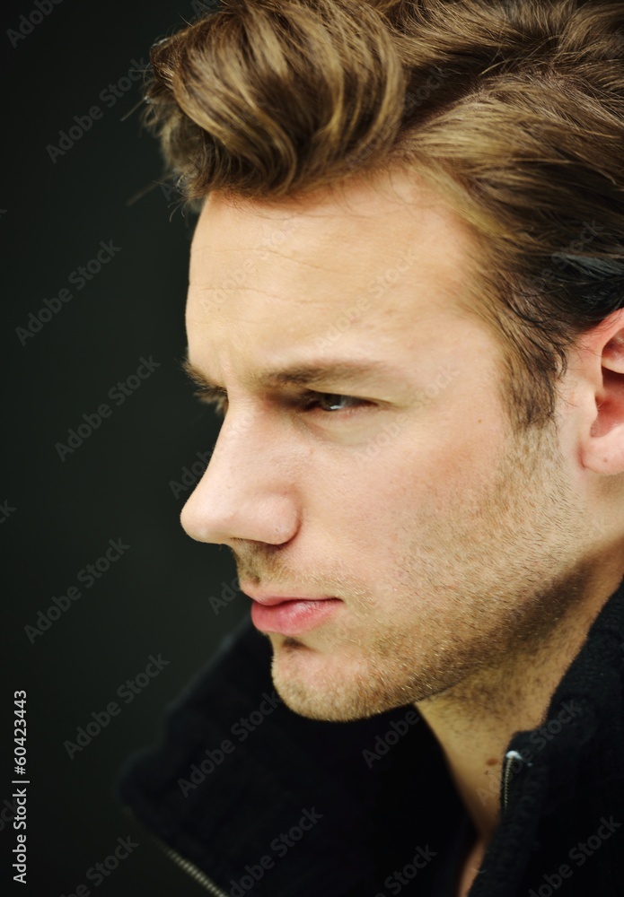 Naklejka premium Young man studio shoot posing closeup