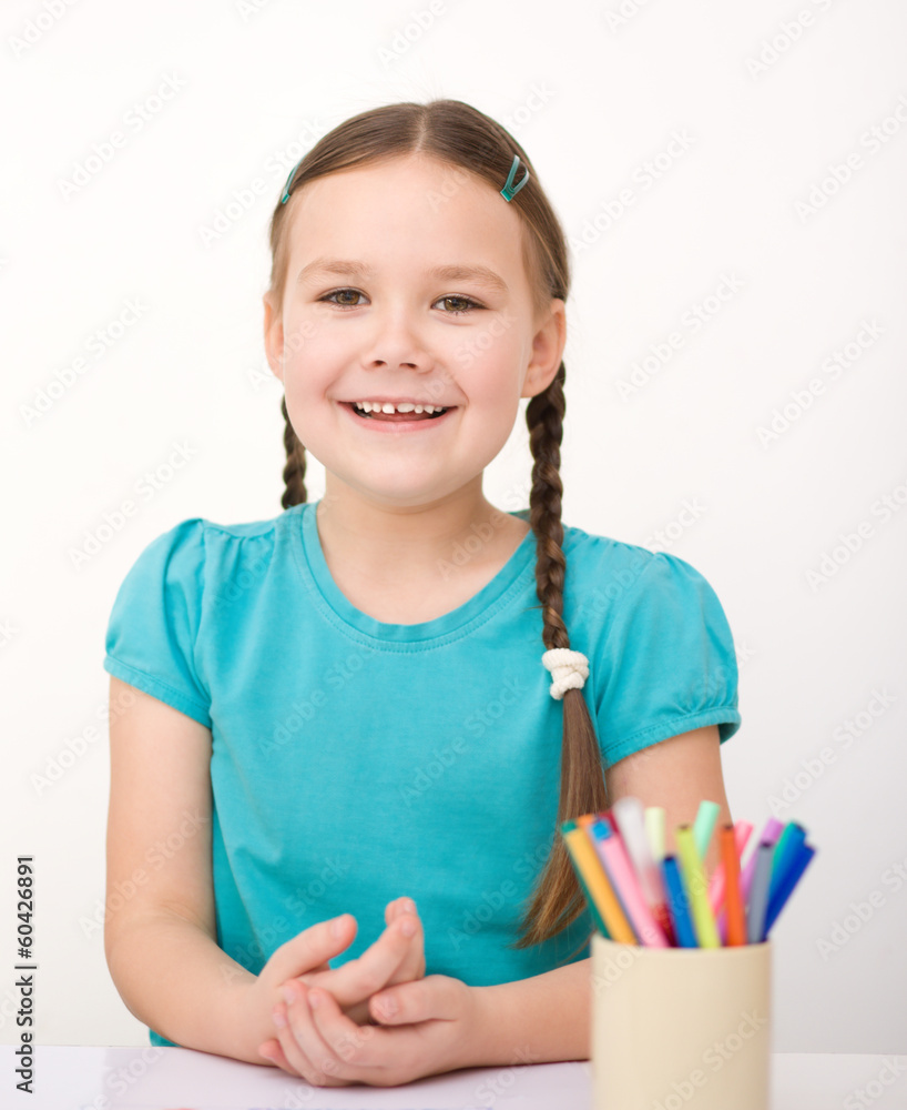 Little girl is drawing using pencils Little girl is drawing using pencils