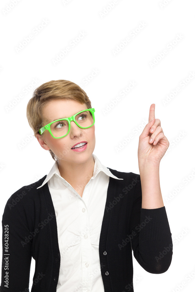 Attractive female in green glasses pointing up.