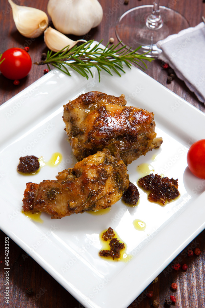 baked rabbit with tomatoes in a dish baked rabbit with tomatoes in a dish