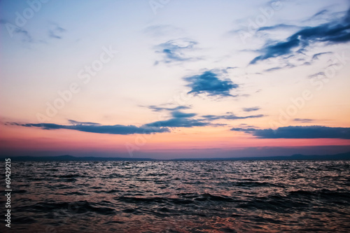 Beautiful tranquility sunrise over sea with cloudscape © azamotkin