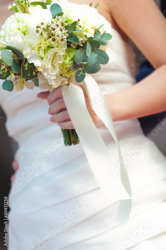 bouquet on bride 's hand photo