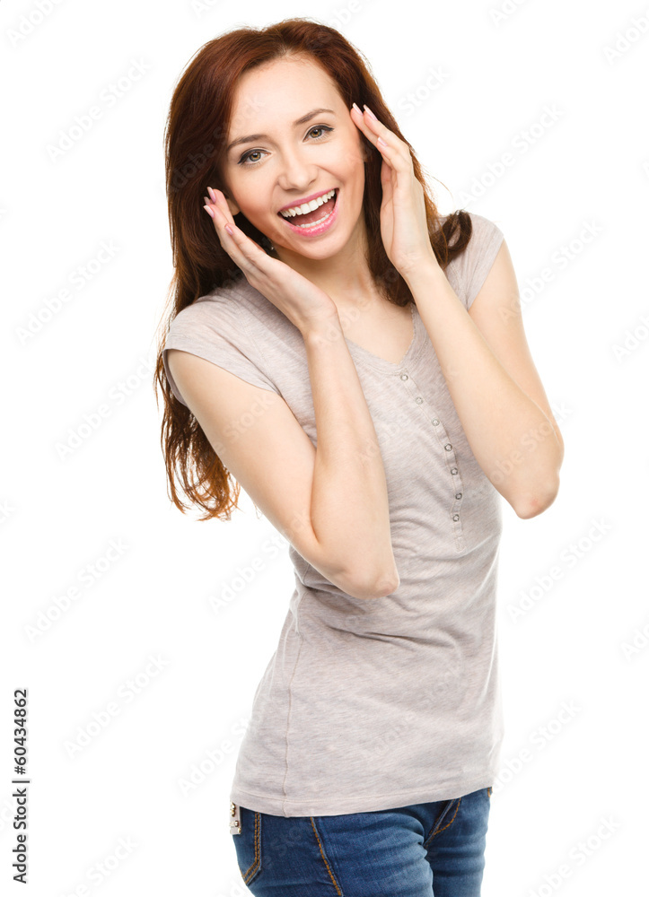 Woman is holding her face in astonishment Woman is holding her face in astonishment