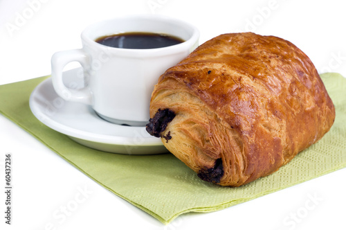 Cup of coffee and chocolate croissant on white background