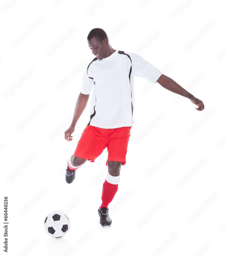 Professional Soccer Player Kicking The Ball