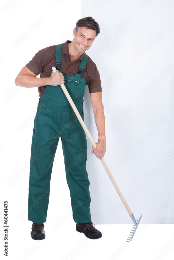 Male Gardener Working With Pitchfork Male Gardener Working With Pitchfork