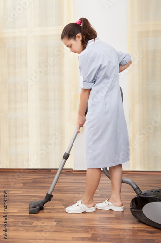 Young Maid Cleaning Floor