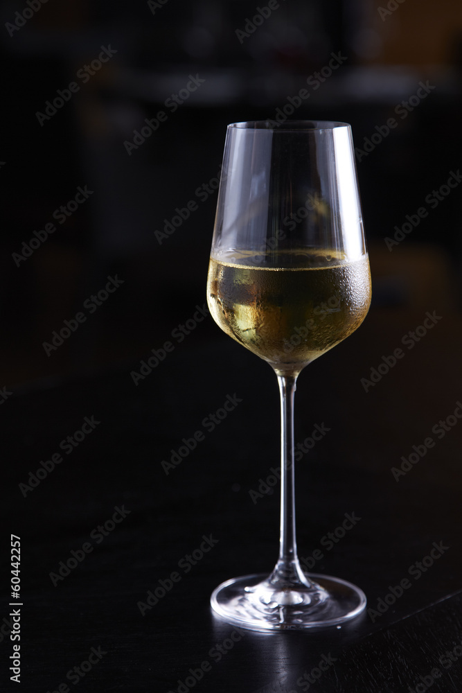 Glass of white wine on table